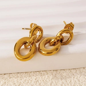 Elegant gold hollow double linked oval hoop earrings on minimalist white display stand