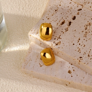 Minimalist gold square stud earrings with polished finish on beige stone display