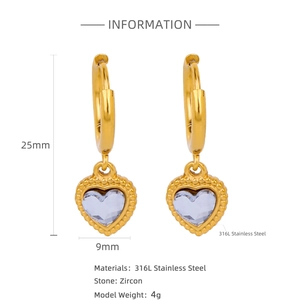 Detail view of 18k gold heart earrings with zircon inlay and 316L steel specs