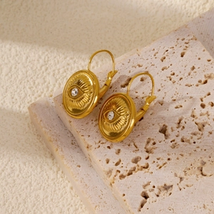 Détail de boucles d'oreilles 18k Mauvais Œil avec diamant sur pierre de travertin