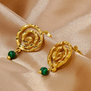 Detailed macro of 18k gold spiral earrings with green malachite textured beads on silk