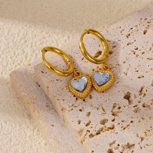 Detail of 18k gold plated hoop earrings with light blue heart gemstone and bead texture
