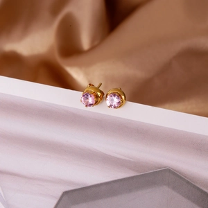 Detail of 18k gold plated stainless steel studs with pink zircon in four-claw setting