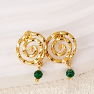 Detailed close-up of 18k gold spiral earrings with green malachite-style beads