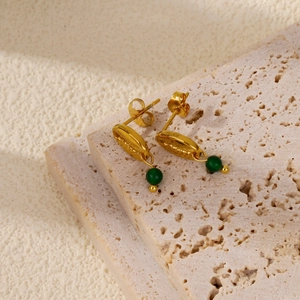 Detail showing 18k gold shell earring design with green malachite-style round bead charms