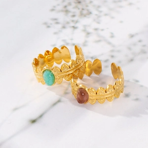 Detailed view of adjustable 18K gold stainless steel leaf rings with oval gemstones