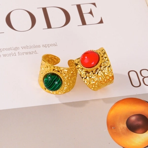 Detailed shot of gold hammered rings with green malachite and red gemstone inlays