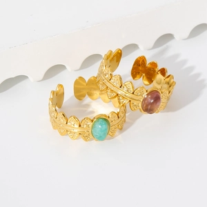 Detail of 18K gold stainless steel ring with embossed leaf texture and oval turquoise stone