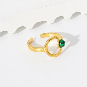 Detailed macro view of 18K gold hollow ring with green malachite stone and open band