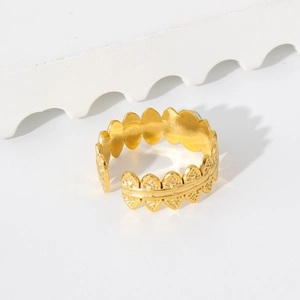 Close-up of 18K gold leaf ring with turquoise inlay and delicate leaf vein textures