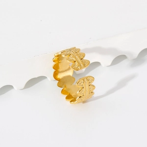 Detail of 18K gold stainless steel ring featuring an open leaf textured pattern