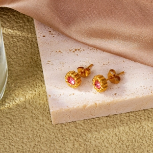 Detail of 18k gold sunflower stud earrings with center pink zircon and butterfly back
