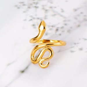 Macro shot of gold snake wrap ring with 18k plating and polished 3D coiled body design