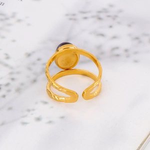 Macro detail of 18k gold plated stainless steel ring with purple stone and hammered texture