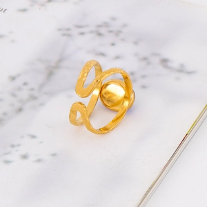 Macro detail of 18k gold plated stainless steel hammered ring with metal ball accent