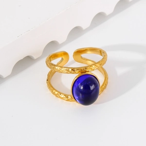 Detail of 18k gold stainless steel double-layered ring with a blue oval gemstone