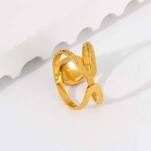 Close-up of gold plated adjustable ring with hammer texture and metallic sphere detail