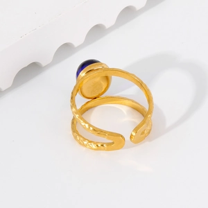 Detail of 18k gold plated stainless steel ring with blue stone and hammered finish