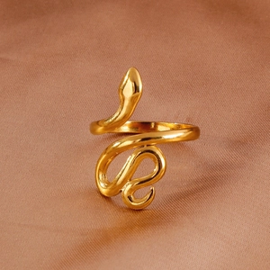 Macro detail of 18k gold plated snake ring showing smooth texture on silk background