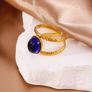 18k gold plated stainless steel hammered ring featuring a deep blue round gemstone