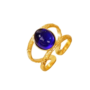 18k gold plated stainless steel ring with oval blue gemstone and hammered texture