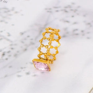 Close-up of a 18k gold stainless steel ring with a pink square gemstone and hollow band