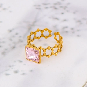 Detailed close-up of 18k gold-plated stainless steel ring with pink square zircon crystal