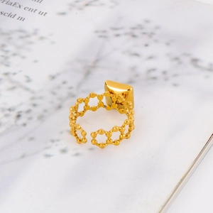 Detail of 18k gold stainless steel ring with hollow hexagonal pattern and square ornament