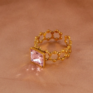 Detail of pink square-cut gemstone on adjustable gold hollow-link chain ring