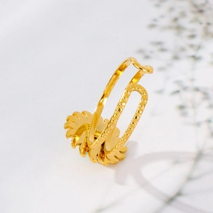 Detail of gold-plated stainless steel double-layer open ring with solar motif design