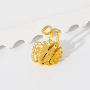 Detail view of gold-plated stainless steel ring with H-letter and sunburst pattern
