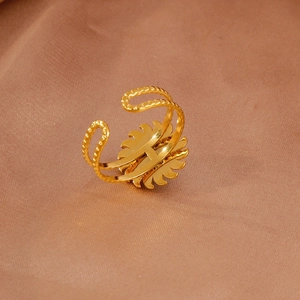 Detail view of gold sunflower ring with double ripple band on elegant satin fabric