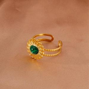 Close-up of gold-plated stainless steel ring with turquoise stone and sun flower detail