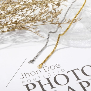 Detailed close-up of gold and silver wheat chain bracelets with lobster clasps