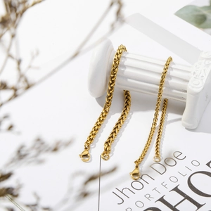 Detail of gold-plated dragon bone link bracelets with lobster clasp on white pillar