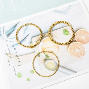 Detail of gold-plated stainless steel wheat and link chain bracelets with lobster clasps