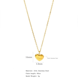 Detail of 316L stainless steel 18K gold heart pendant with engraved Love script lettering