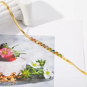 Detail of gold herringbone necklace with multi-color rainbow cubic zirconia stones