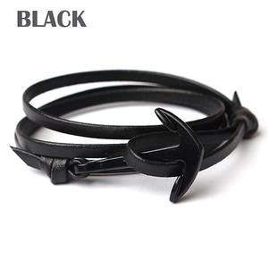 Macro detail of black leather multi-layer wrap bracelet with a nautical anchor clasp