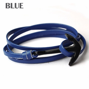 Detail of multi-layer blue leather strap bracelet with black polished anchor clasp