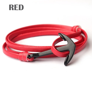 Detail of red leather wrap bracelet with white stitching and black metal anchor hook