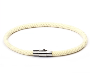 Detailed view of cream woven rope cord with polished silver magnetic metal clasp