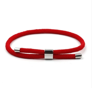 Detailed view of red braided rope bracelet with adjustable matte silver metal sliding clasp