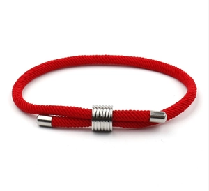 Detailed macro view of woven red string bracelet with adjustable silver metal slide buckle