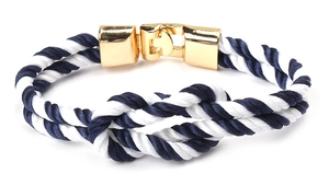 Nautical braided bracelet in navy and white with a polished gold metal clasp detail