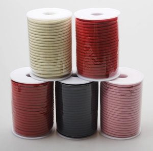 Set of five multi-colored woven cord spools including red and black for DIY jewelry making