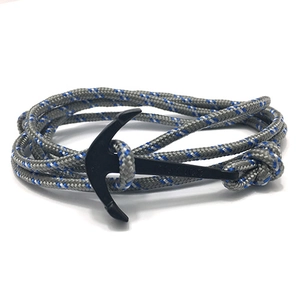 Detail of nautical braided bracelet with matte black anchor clasp in grey and blue
