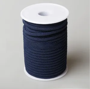 Macro detail of navy blue woven cord spool for DIY jewelry and handicraft making