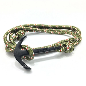 Macro shot of Viking anchor bracelet featuring green paracord and black metal clasp