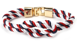 Detail of nautical rope bracelet with tricolor braid and gold metallic clasp